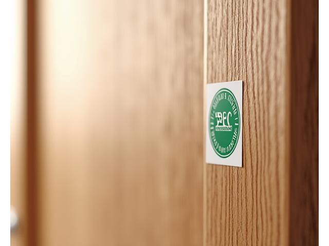 Close-up of a wooden door with an FSC certification logo prominently displayed, demonstrating responsible sourcing.